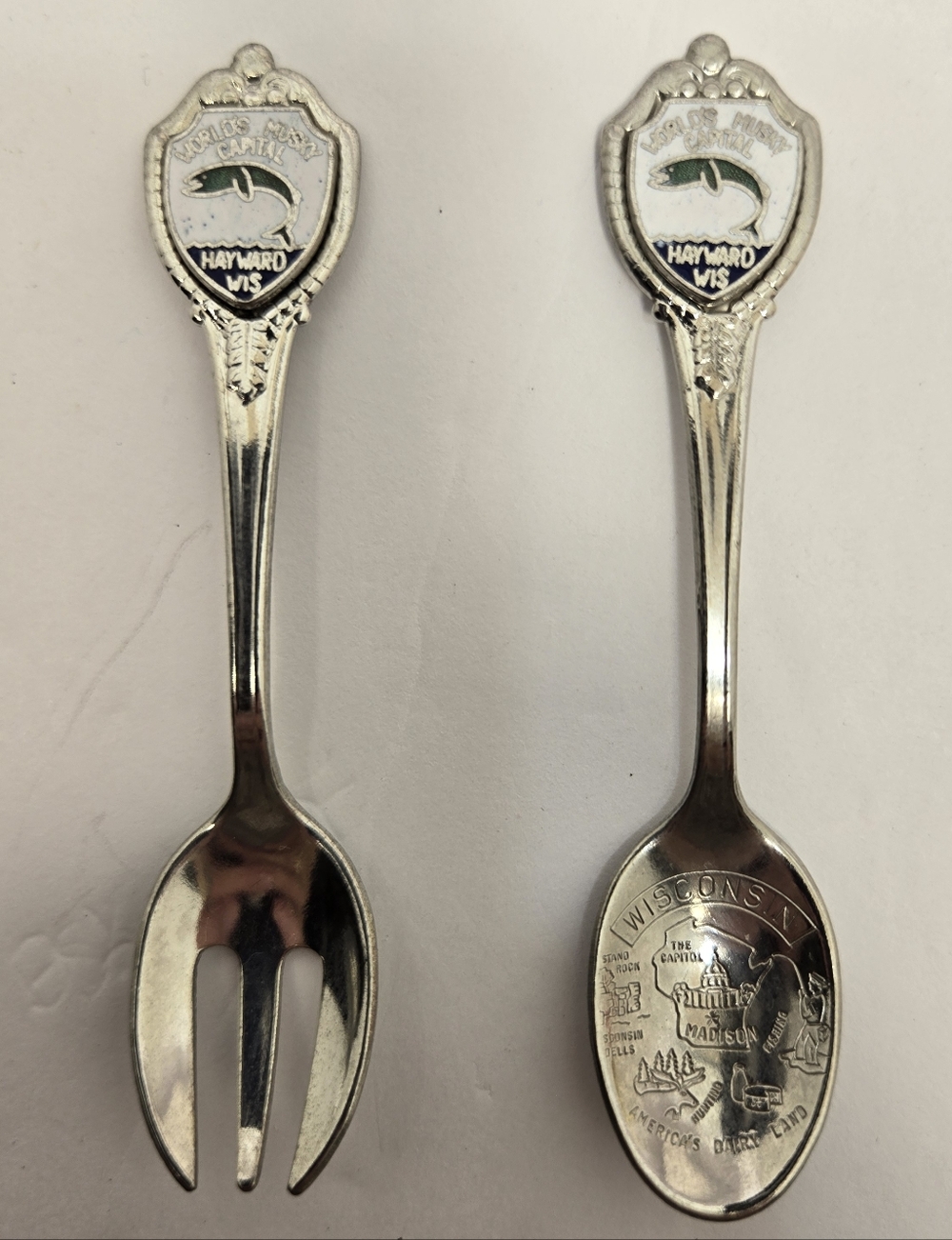 Souvenir spoon and fork set. Landmarks and themes from Hayward, WS Musky Capital